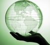 Person holding green globe