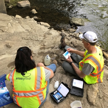 Two employees testing water