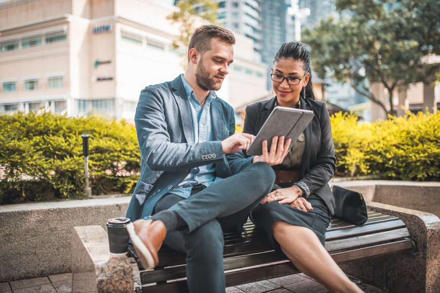 Business Man and Woman Using Tablet
