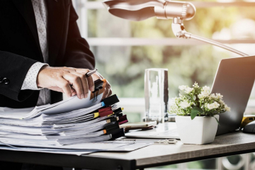 Person going through stack of files