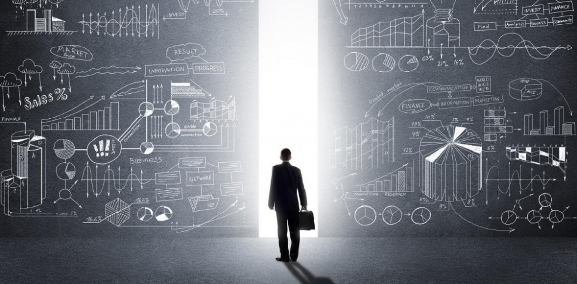 Business man in front of blackboard with graphs