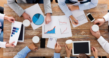 people reviewing graphs and pie charts