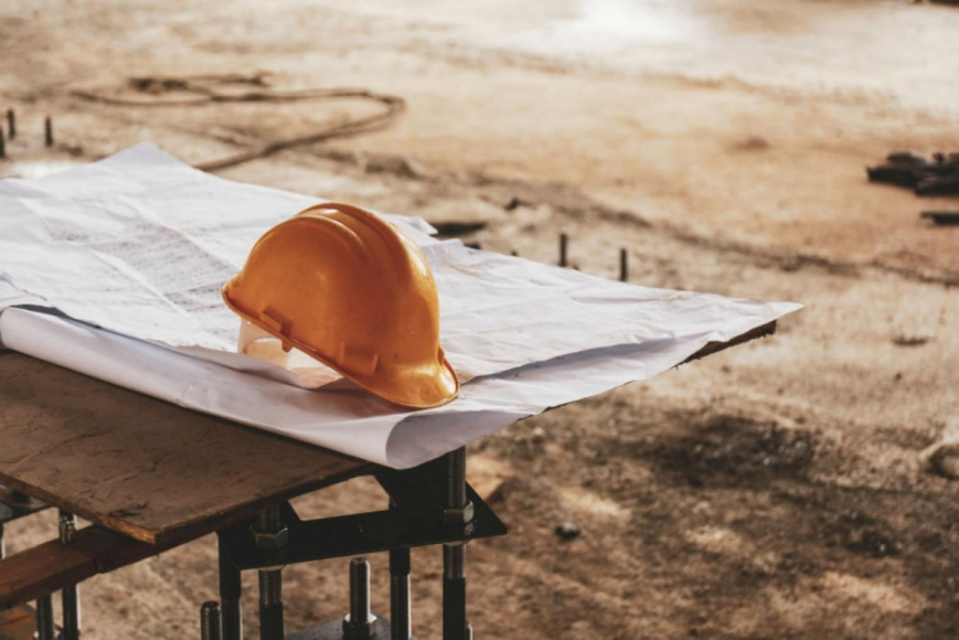 hardhat on top of building plans