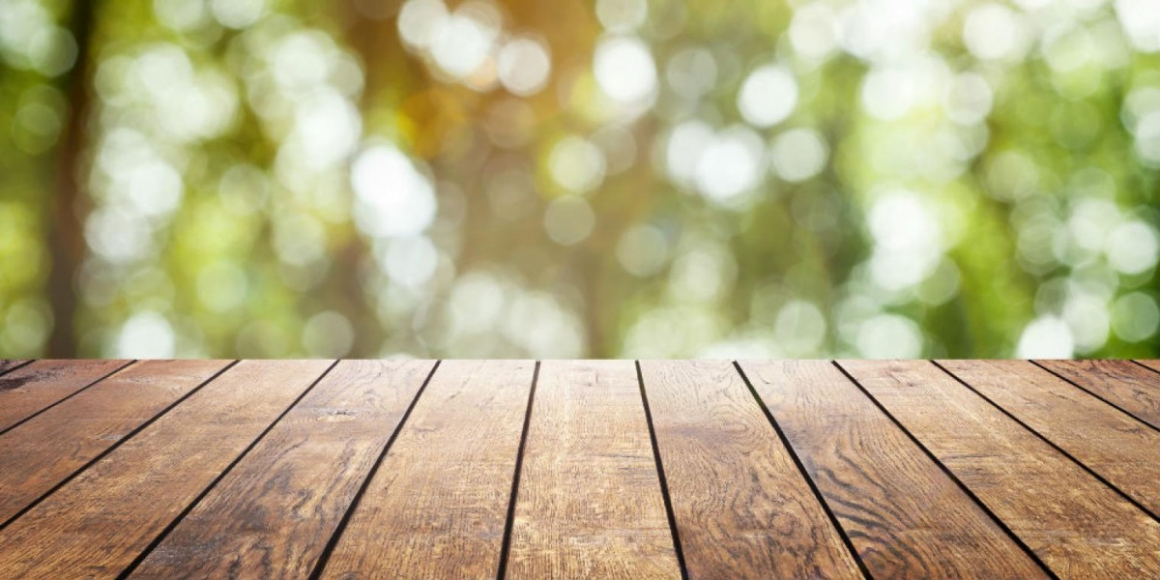 wooden platform in front of green background