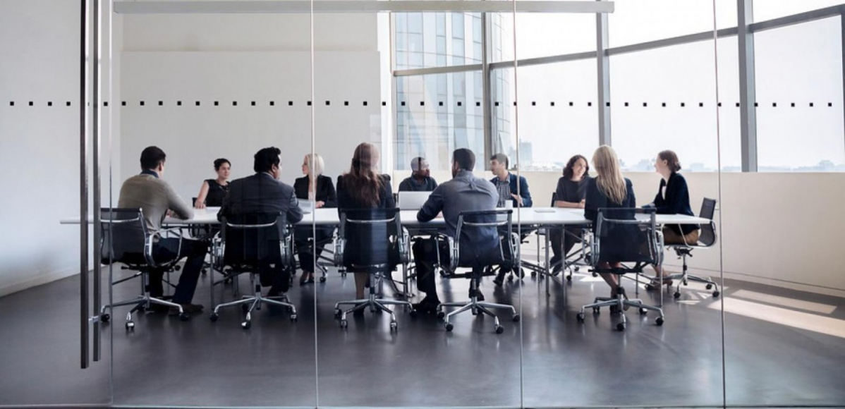 Group of business people sitting around a table 