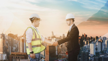 Business man and construction worker shaking hands