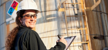 engineer writing on clipboard