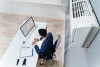 man sitting in office with air conditioner 